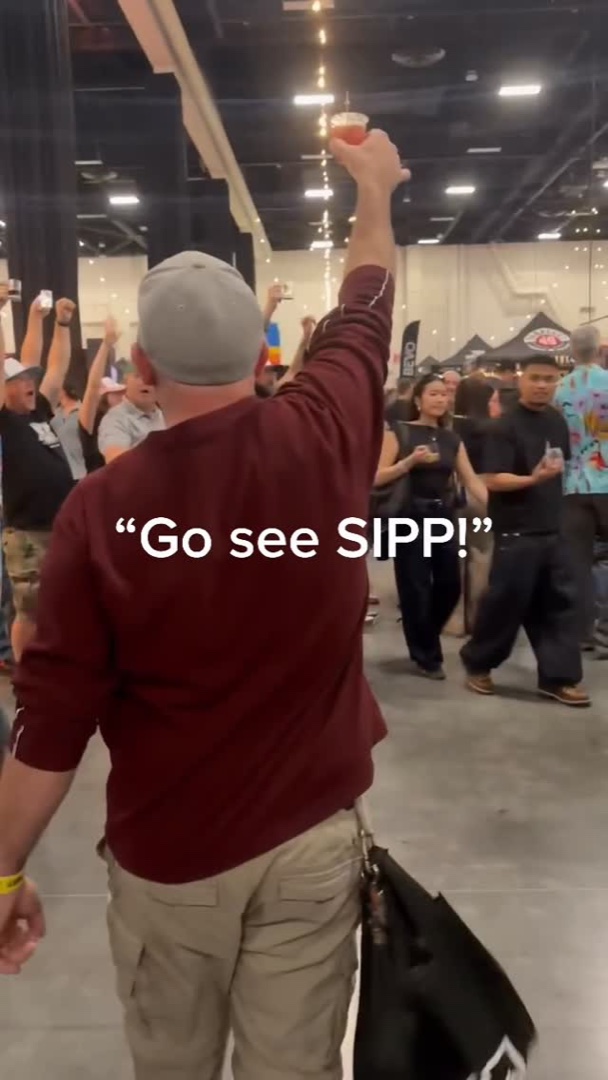 Sipp fan raising a glass at a trade event