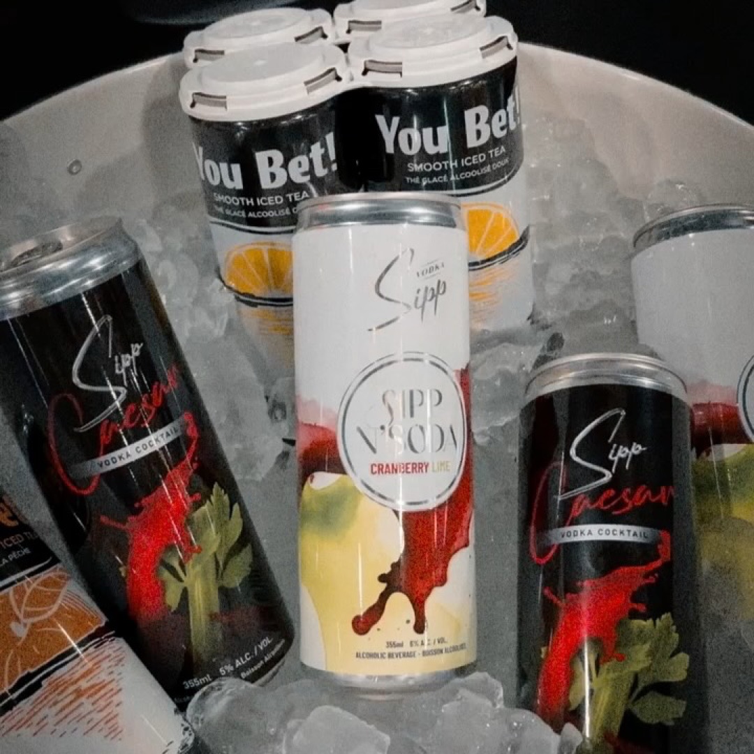 Sipp N'Soda Cranberry Lime can centered in a tub of ice with You Bet and Caesar cans